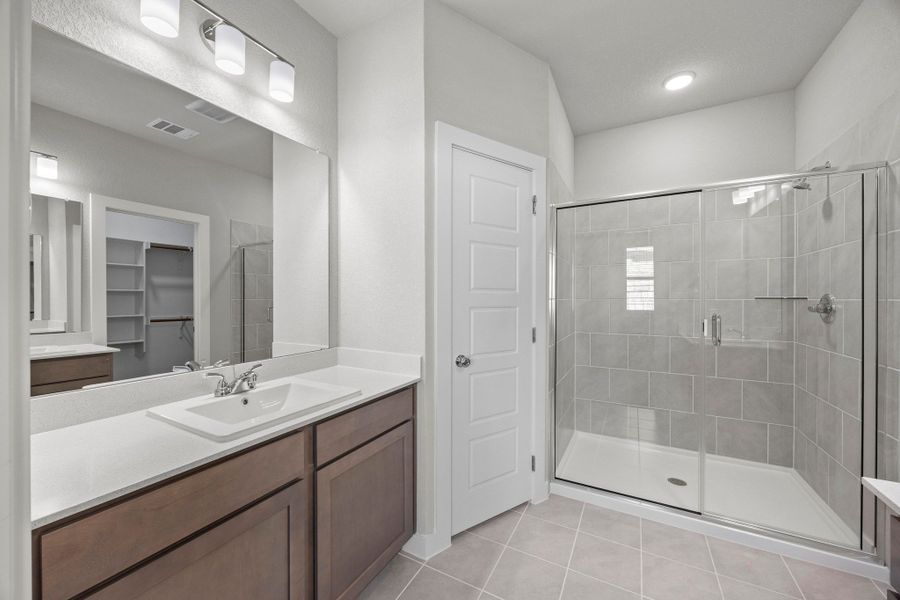 Primary Bathroom in the Cedar home plan by Trophy Signature Homes – REPRESENTATIVE PHOTO