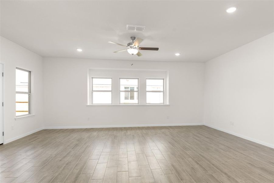 Unfurnished room with visible vents, light wood-style flooring, recessed lighting, and a ceiling fan
