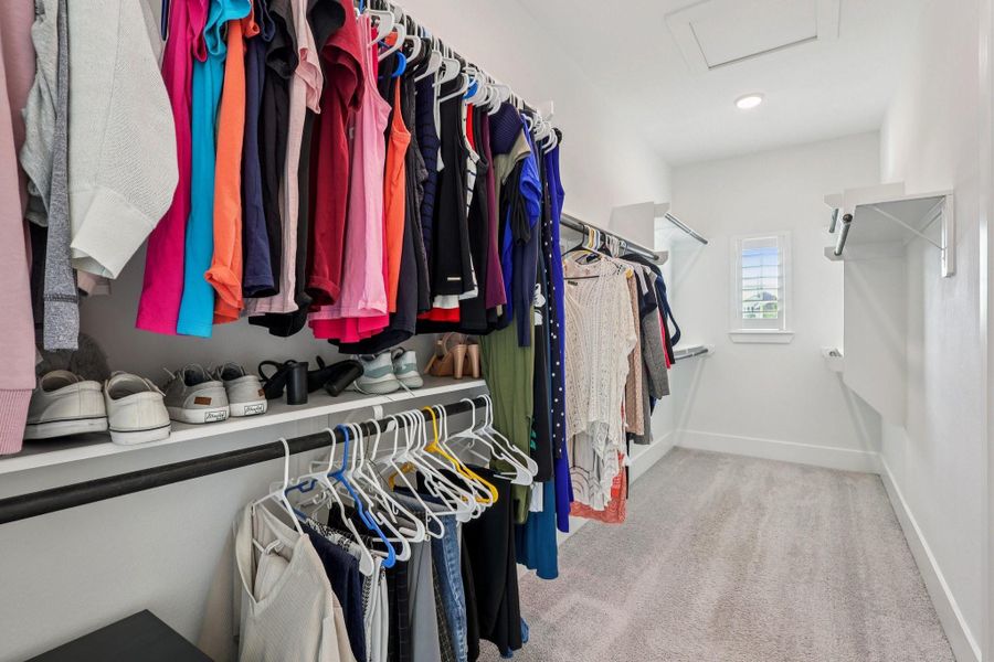 Primary Closet - Abundant Space, Window with custom shade allows natural light. Also leads into the laundry room.