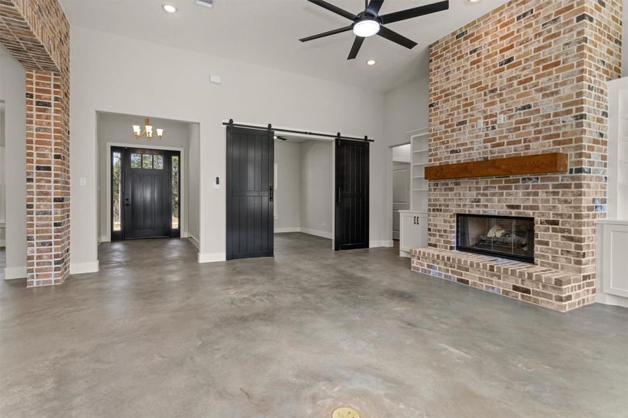 Just beyond the striking double barn doors off the living room, you’ll find a versatile office, study, or library space designed for both privacy and style. The doors add a touch of rustic charm while allowing the room to feel connected to the main living area when open — and tucked away for quiet focus when closed.
