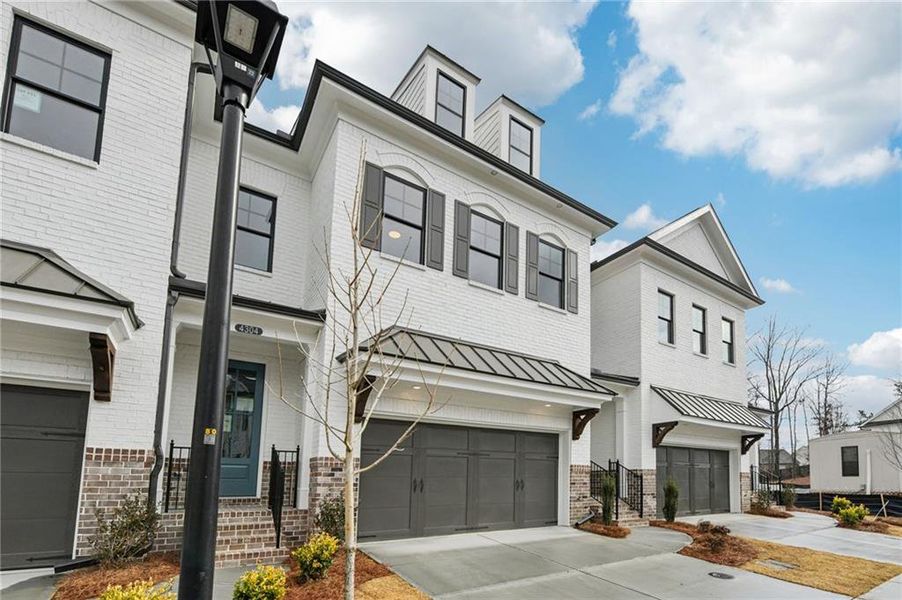 Front exterior of a new home in Millcroft Townhomes, Buford, GA, highlighting curb appeal (Image 1). Front exterior of a new home in Millcroft Townhomes, Buford, GA, highlighting curb appeal (Image 1).