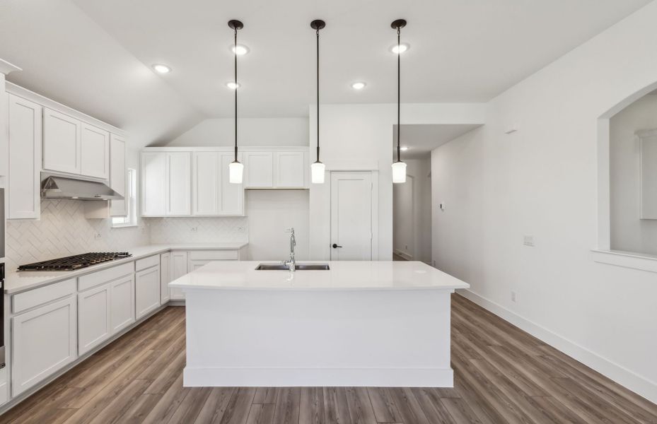 Spacious kitchen with oversized island *real home pictured