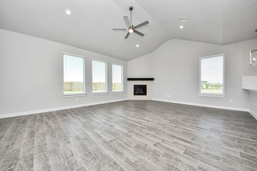 Welcome family and guests to your charming living room! With its high ceilings, recessed lighting, ceiling fan, custom paint, beautiful flooring, and large windows that let in abundant natural light, this room is perfect for gatherings. Sample photo of completed home with similar floor plan. Actual colors and selections may vary. Welcome family and guests to your charming living room! With its high ceilings, recessed lighting, ceiling fan, custom paint, beautiful flooring, and large windows that let in abundant natural light, this room is perfect for gatherings. Sample photo of completed home with similar floor plan. Actual colors and selections may vary.