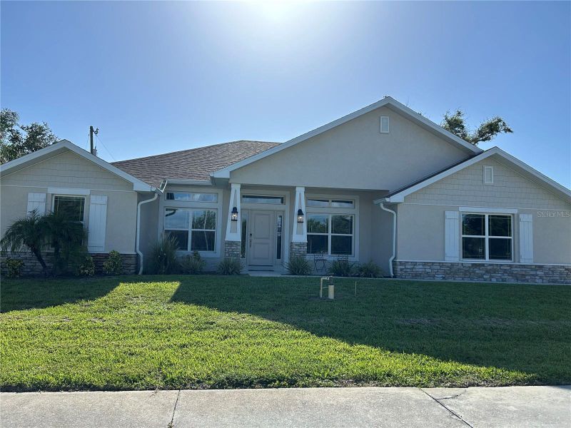 Front exterior of a new home in Venice, Venice, FL, highlighting curb appeal (Image 1).