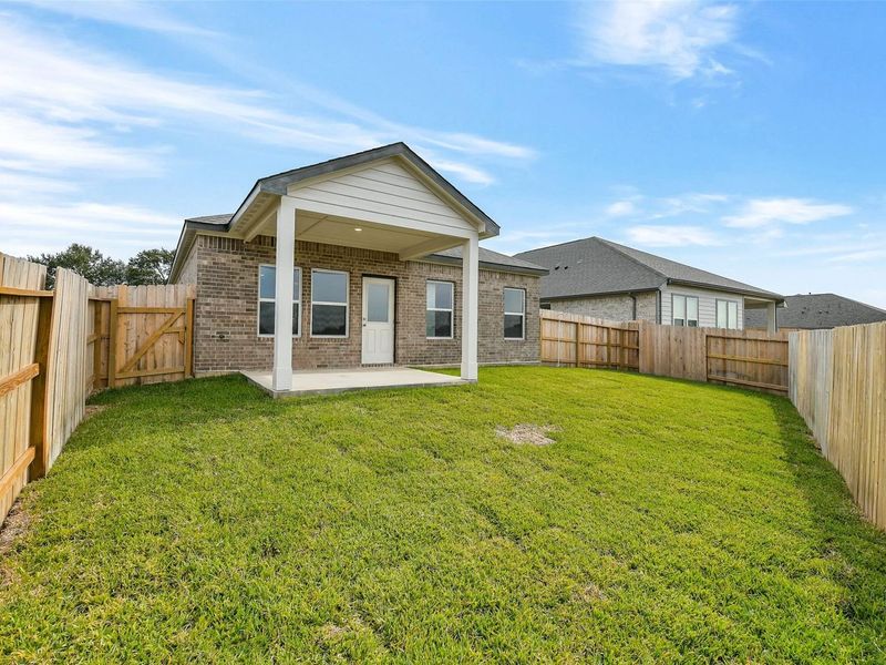 Exterior details and patio area of a home in Windmill Estates, Magnolia (Image 23).