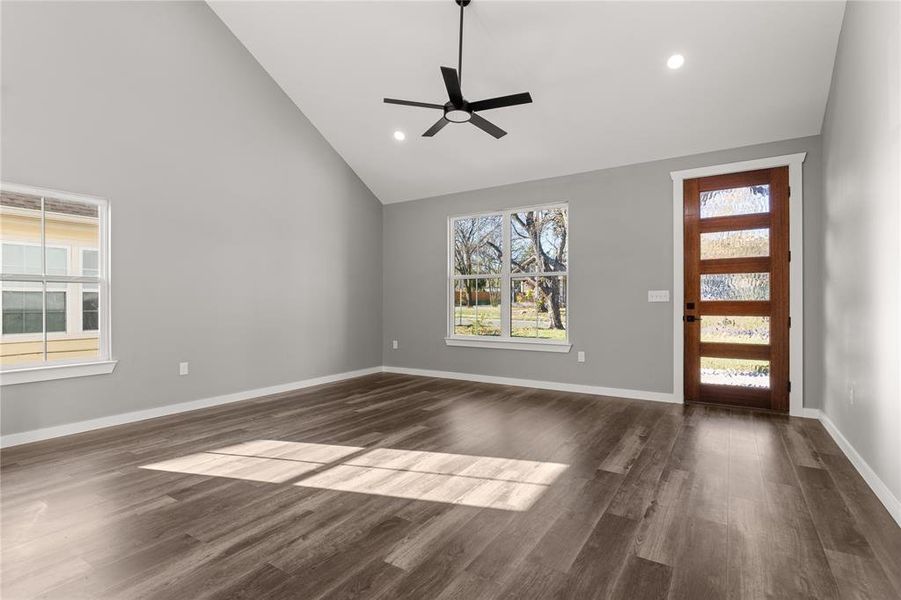 Entryway featuring dark wood finished floors, high vaulted ceiling, recessed lighting, and a ceiling fan