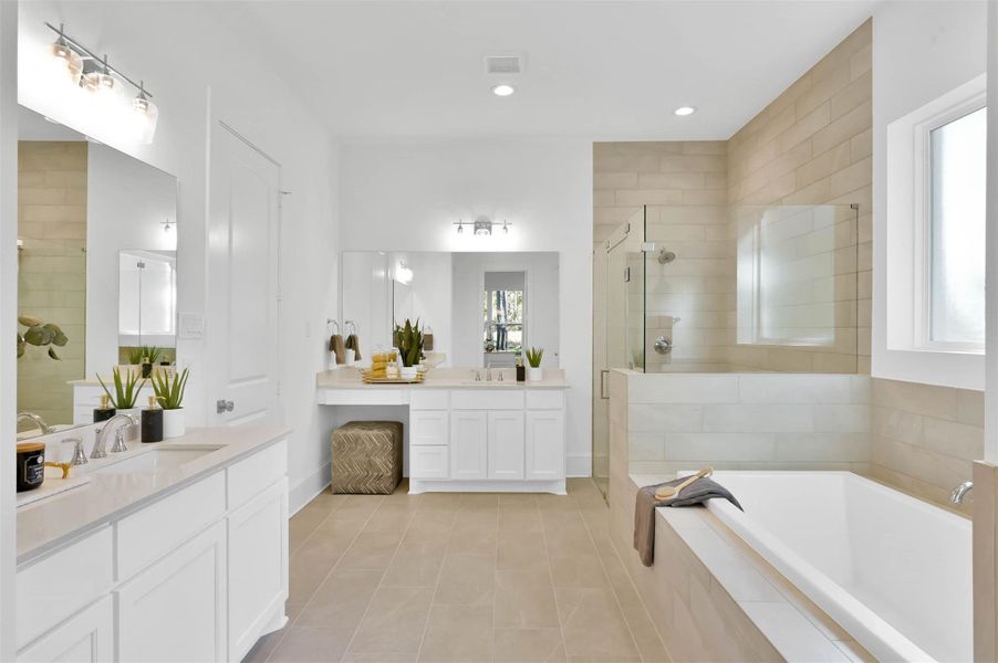 Gorgeous primary bath has separate vanities, custom cabinets and quartz counters. Gorgeous primary bath has separate vanities, custom cabinets and quartz counters.