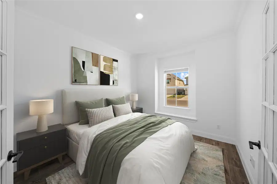 Bedroom featuring ornamental molding and wood finished floors Bedroom featuring ornamental molding and wood finished floors