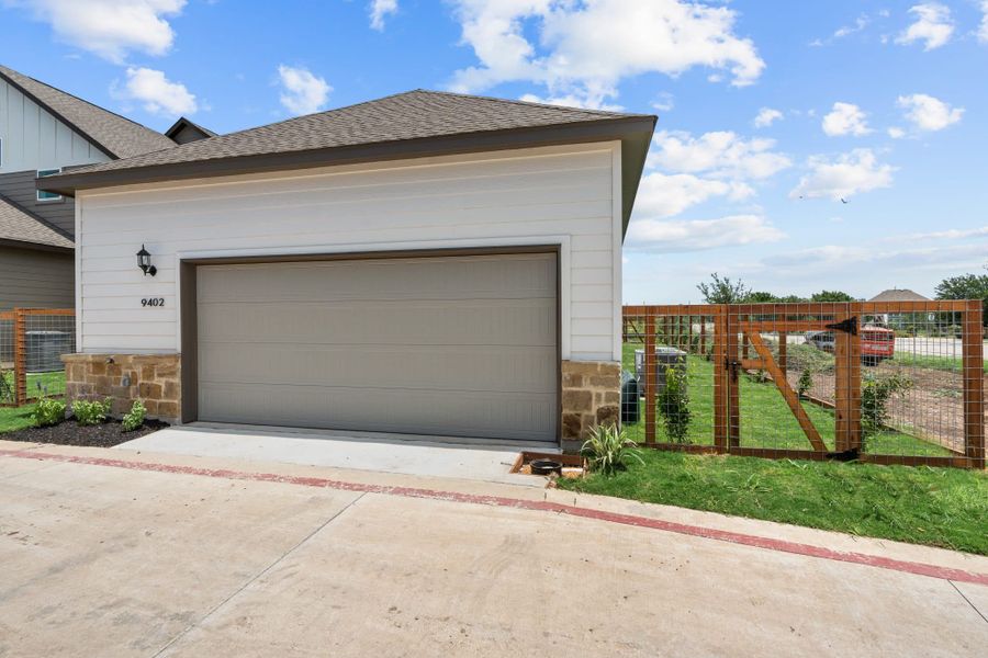 Front exterior of a new home in The Crossvine, Schertz, TX, highlighting curb appeal (Image 19). Front exterior of a new home in The Crossvine, Schertz, TX, highlighting curb appeal (Image 19).
