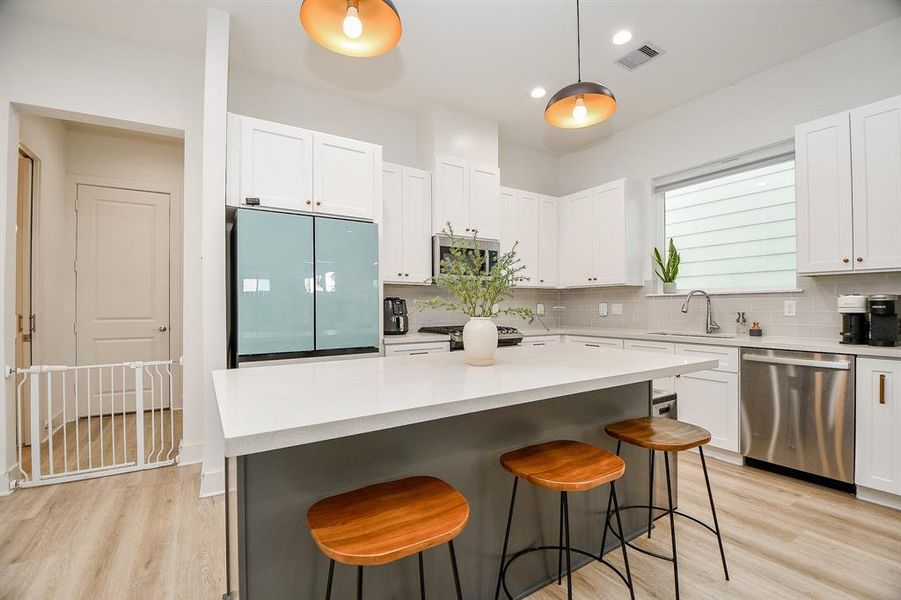 Kitchen offer natural lighting with the warm wood flooring creating a welcoming and functional space.