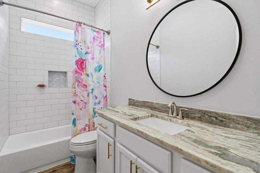 Second full bath with fully tiled tub/shower combo- all the walk to the ceiling! Leathered granite countertop and framed mirror. Second full bath with fully tiled tub/shower combo- all the walk to the ceiling! Leathered granite countertop and framed mirror.