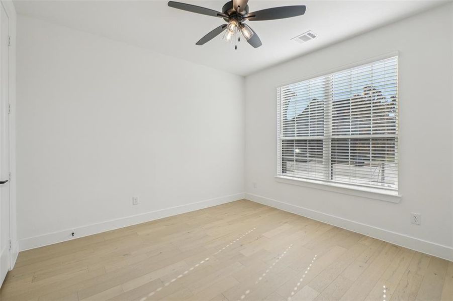Unfurnished room featuring light wood-style flooring and ceiling fan Unfurnished room featuring light wood-style flooring and ceiling fan