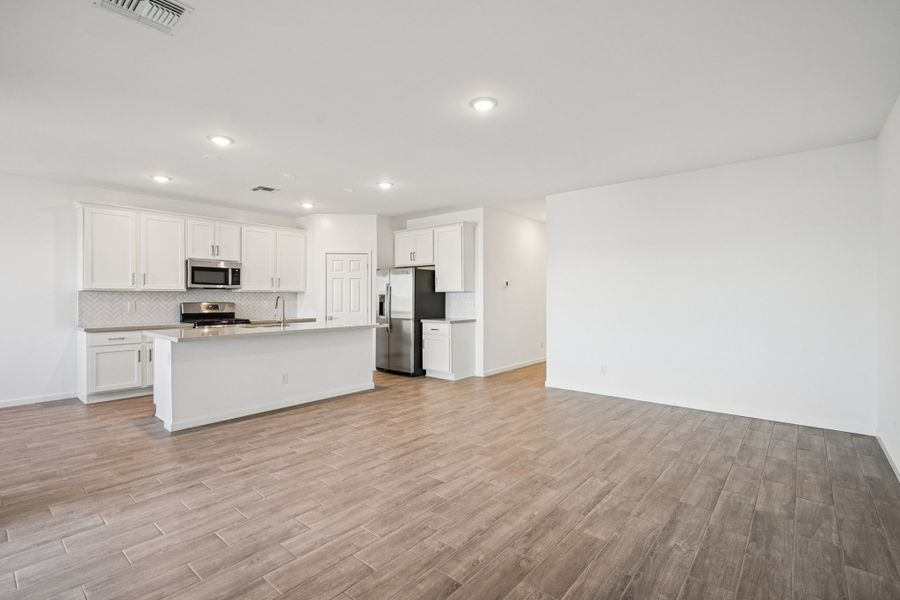 Great room and kitchen. Options and finishes may vary by community