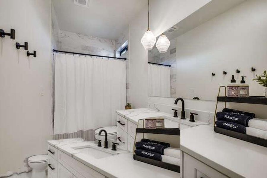 Bathroom featuring vanity and curtained shower