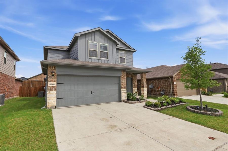 Front exterior of a new home in Wildcat Ranch, Crandall, TX, highlighting curb appeal (Image 2). Front exterior of a new home in Wildcat Ranch, Crandall, TX, highlighting curb appeal (Image 2).