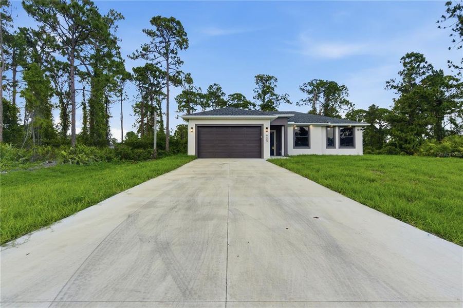 Front exterior of a new home in , Lehigh Acres, FL, highlighting curb appeal (Image 19).