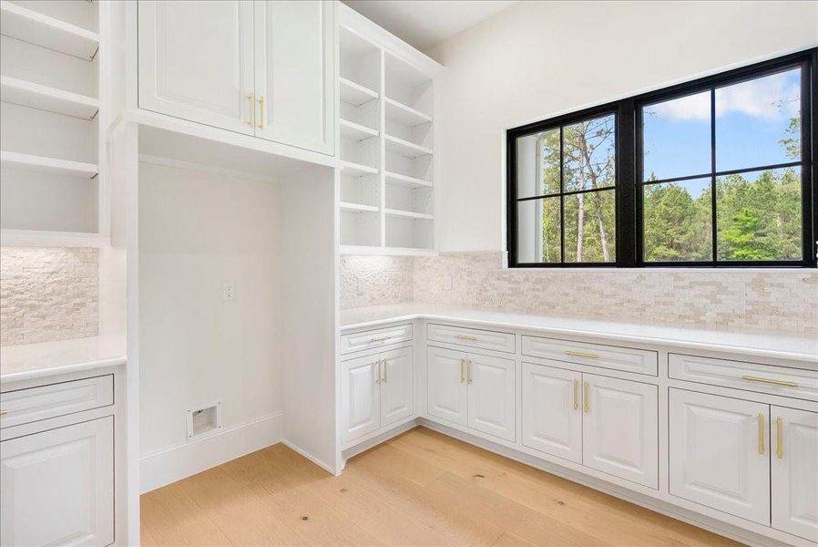 A true butler’s pantry offers generous prep and staging space, making large-scale entertaining feel effortless while keeping the main kitchen beautifully composed.