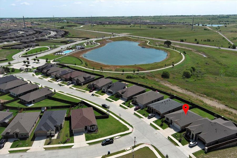 Aerial view of property's location with a nearby body of water and nearby suburban area Aerial view of property's location with a nearby body of water and nearby suburban area