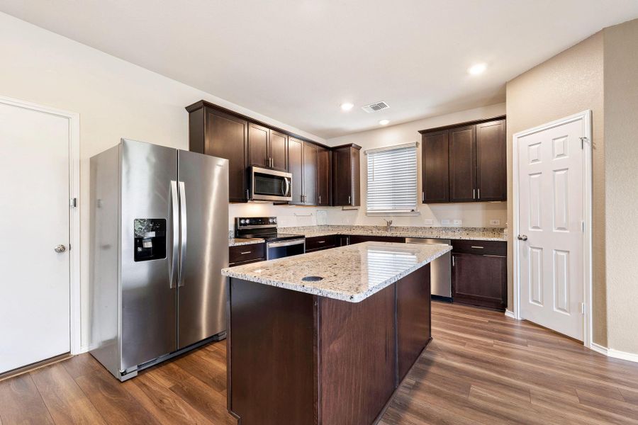 Culinary creations come to life in this modern kitchen, featuring an inviting island and elegant granite countertops. Culinary creations come to life in this modern kitchen, featuring an inviting island and elegant granite countertops.