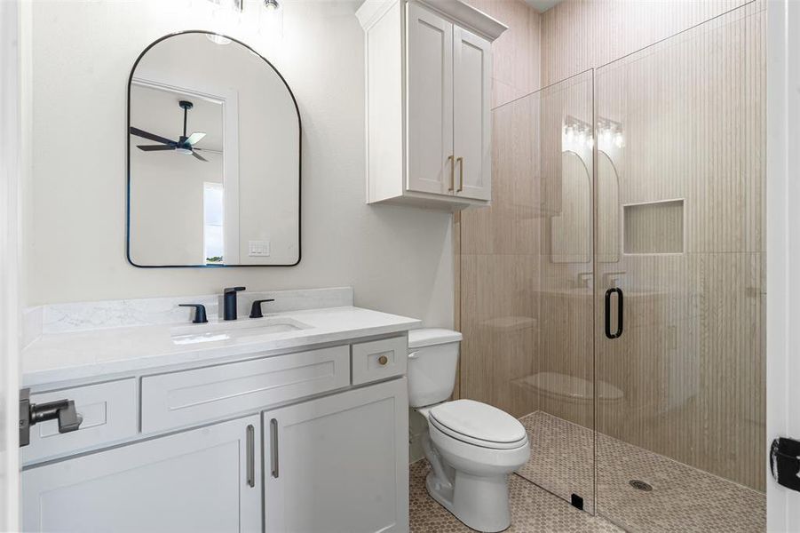 Full bathroom featuring vanity, a stall shower, tile patterned flooring, and a ceiling fan Full bathroom featuring vanity, a stall shower, tile patterned flooring, and a ceiling fan