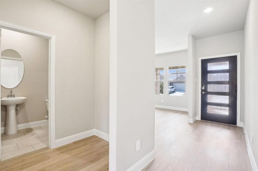 Foyer entrance featuring light wood-style flooring and recessed lighting Foyer entrance featuring light wood-style flooring and recessed lighting