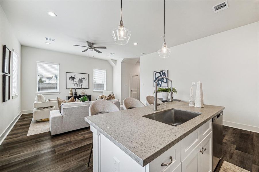 Kitchen includes quartz countertops andundermount stainless steel sink on the island.