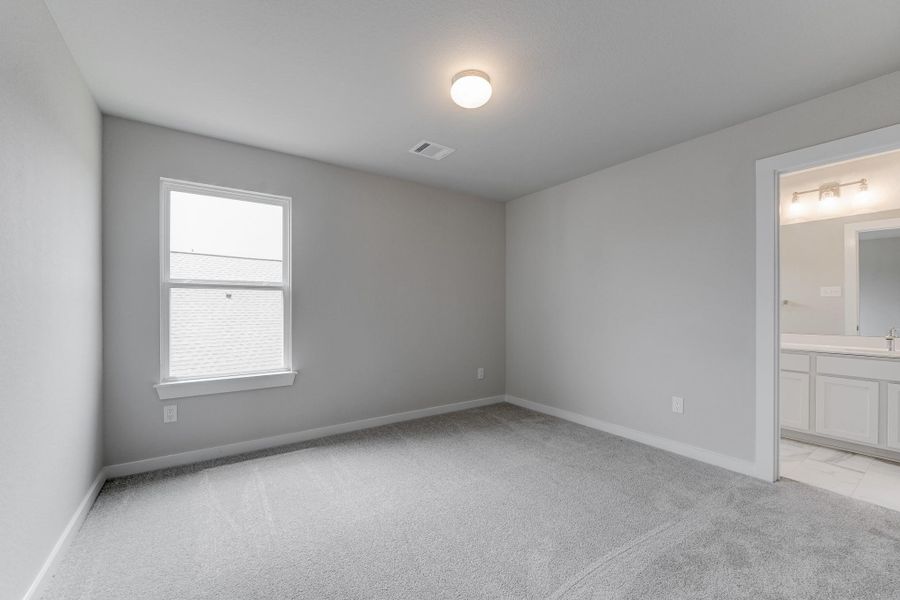 Home is equipped with a guest suite. Guests have the privacy of their own bathroom within. Sample photo of completed home with similar floor plan. As-built interior colors and selections may vary.