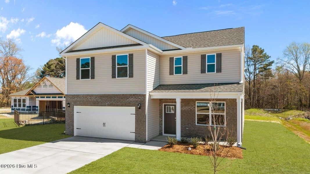 Front exterior of a new home in Villa Grande, Winterville, NC, highlighting curb appeal (Image 18). Front exterior of a new home in Villa Grande, Winterville, NC, highlighting curb appeal (Image 18).