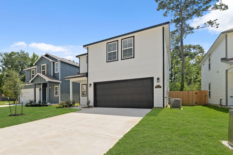 Front exterior of a new home in Maple Heights, Porter, TX, highlighting curb appeal (Image 2). Front exterior of a new home in Maple Heights, Porter, TX, highlighting curb appeal (Image 2).