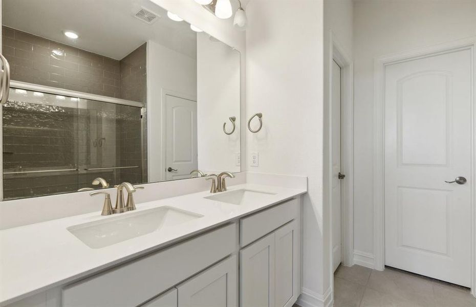 Spacious owner's bathroom with dual vanity *real home pictured