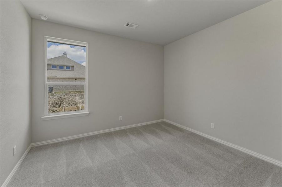 Room featuring light gray carpet, white baseboards, and neutral wall paint Room featuring light gray carpet, white baseboards, and neutral wall paint
