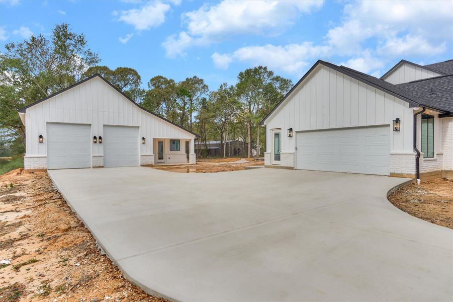 Expansive motor court showcasing the main home and the separate casita, each with its own garage—offering exceptional parking, privacy, and multi-generational flexibility.
