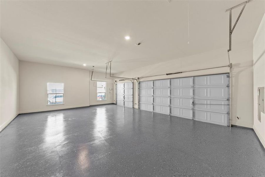 Garage with baseboards and recessed lighting Garage with baseboards and recessed lighting