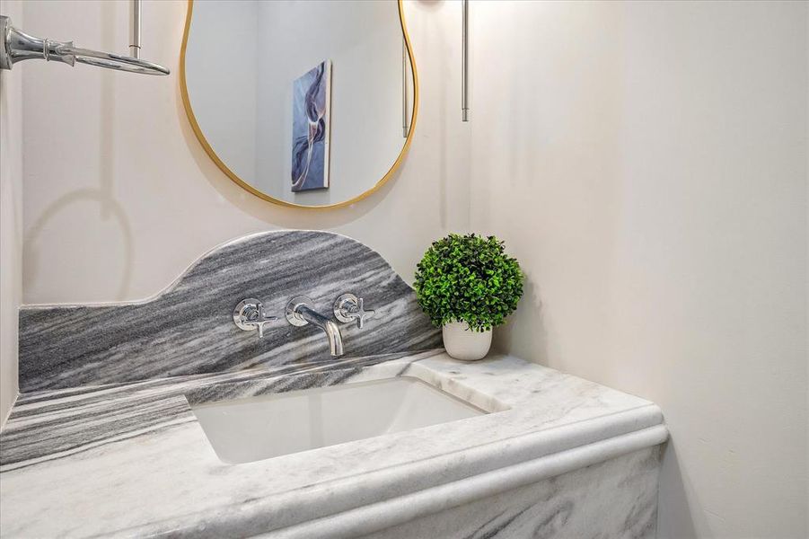 Powder, Shadow Storm honed stone countertop, wall-mount faucet, designer mirror Powder, Shadow Storm honed stone countertop, wall-mount faucet, designer mirror