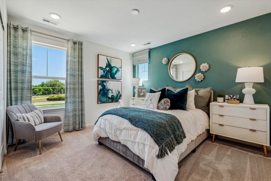 A bedroom with a bed and a chair. A bedroom with a bed and a chair.