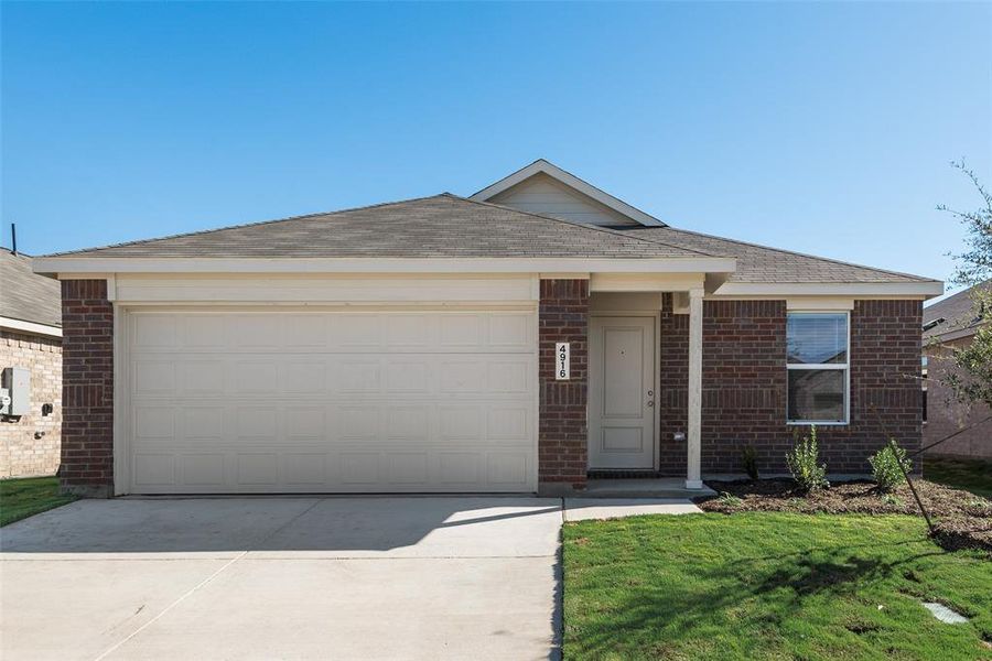 Ranch-style home with a garage and a front lawn