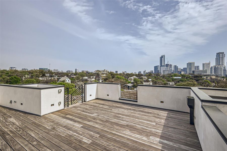City skyline vistas from this spacious rooftop deck with rich wooden flooring and contemporary railings. City skyline vistas from this spacious rooftop deck with rich wooden flooring and contemporary railings.