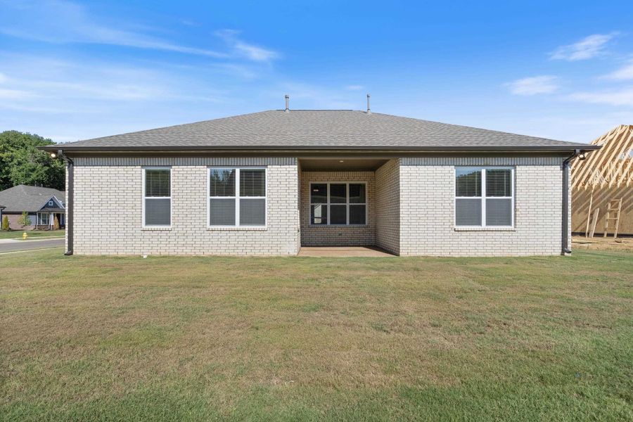 Brick exterior with a covered patio and multiple windows Brick exterior with a covered patio and multiple windows