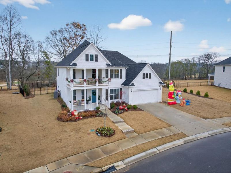 Front exterior of a new home in Reunion, Flowery Branch, GA, highlighting curb appeal (Image 20). Front exterior of a new home in Reunion, Flowery Branch, GA, highlighting curb appeal (Image 20).