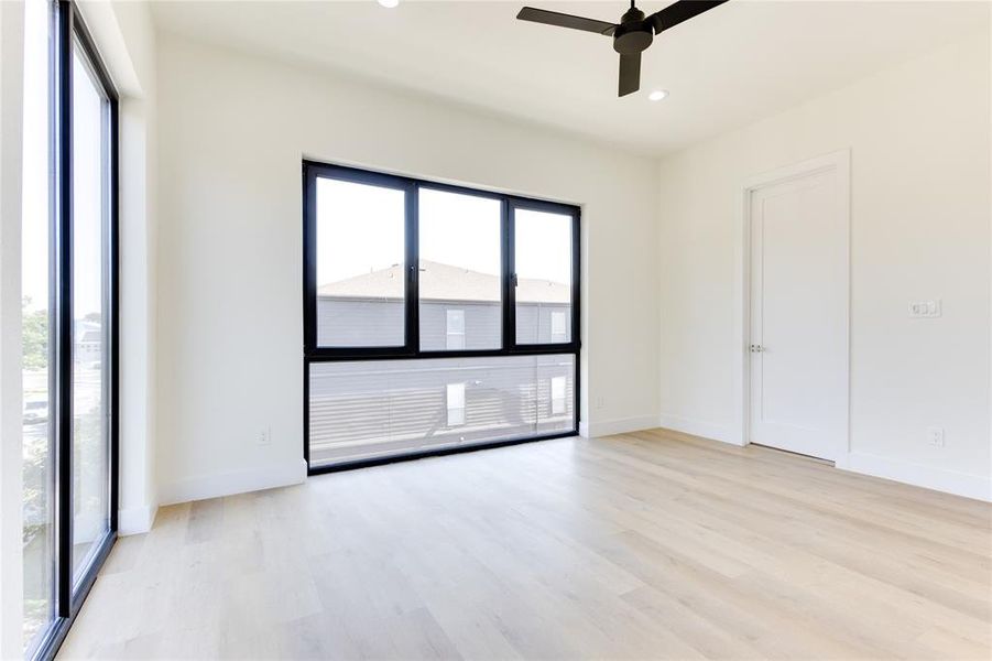 Spare room with light wood-type flooring and ceiling fan