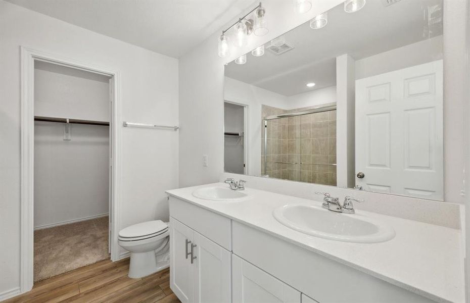 Elegant owner's bathroom with dual vanity *real home pictured