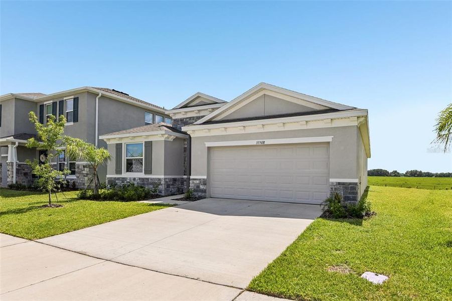 Front exterior of a new home in , Wesley Chapel, FL, highlighting curb appeal (Image 1). Front exterior of a new home in , Wesley Chapel, FL, highlighting curb appeal (Image 1).