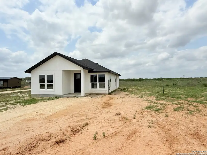 Front exterior of a new home in , La Vernia, TX, highlighting curb appeal (Image 1). Front exterior of a new home in , La Vernia, TX, highlighting curb appeal (Image 1).