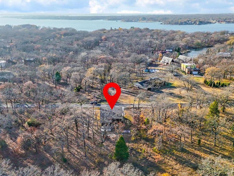 Aerial view of property and surrounding area with a heavily wooded area Aerial view of property and surrounding area with a heavily wooded area