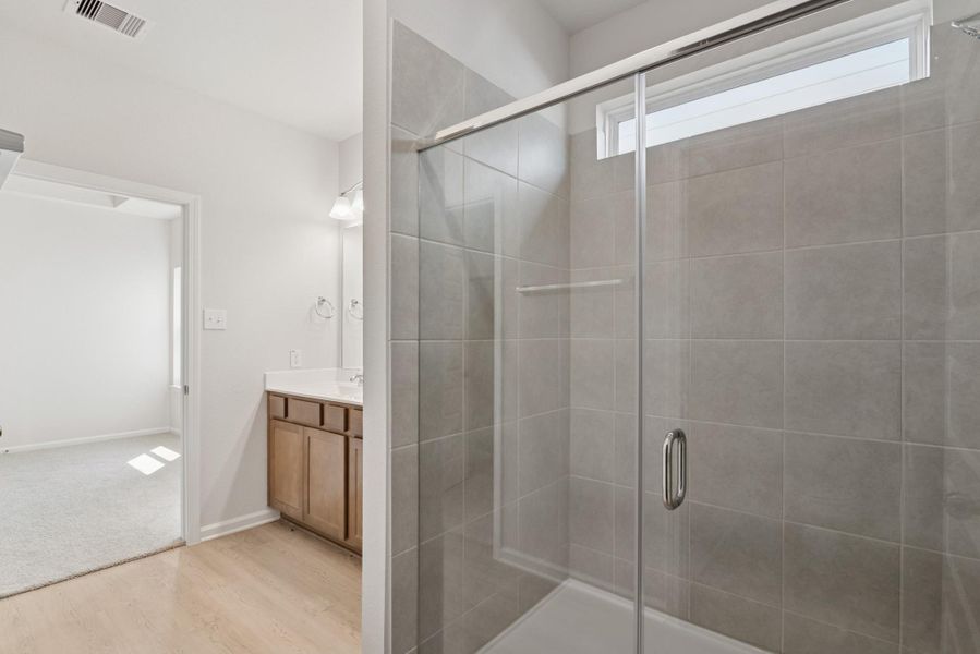 The Mockingbird II- Primary Bathroom with Dual Vanities and Walk-in Shower The Mockingbird II- Primary Bathroom with Dual Vanities and Walk-in Shower