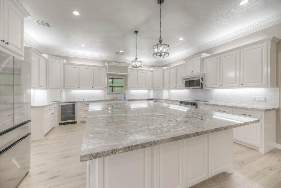 Kitchen view 2 with great lighting and huge granite countertops Kitchen view 2 with great lighting and huge granite countertops