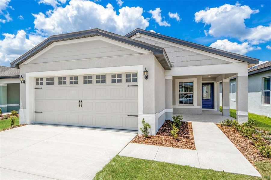 Front exterior of a new home in Gum Lake Preserve, Lake Alfred, FL, highlighting curb appeal (Image 1). Front exterior of a new home in Gum Lake Preserve, Lake Alfred, FL, highlighting curb appeal (Image 1).