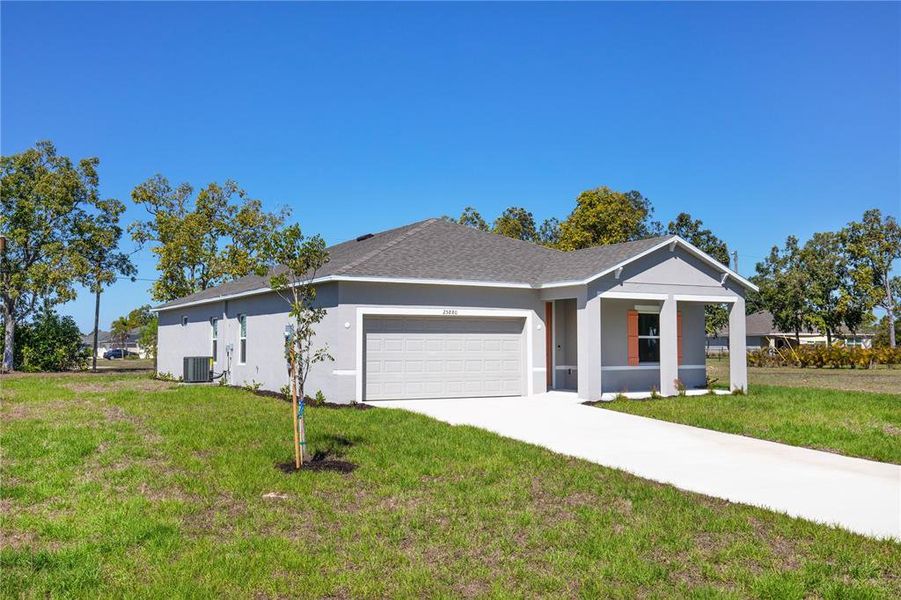 Front exterior of a new home in Burnt Store Village, Punta Gorda, FL, highlighting curb appeal (Image 13).