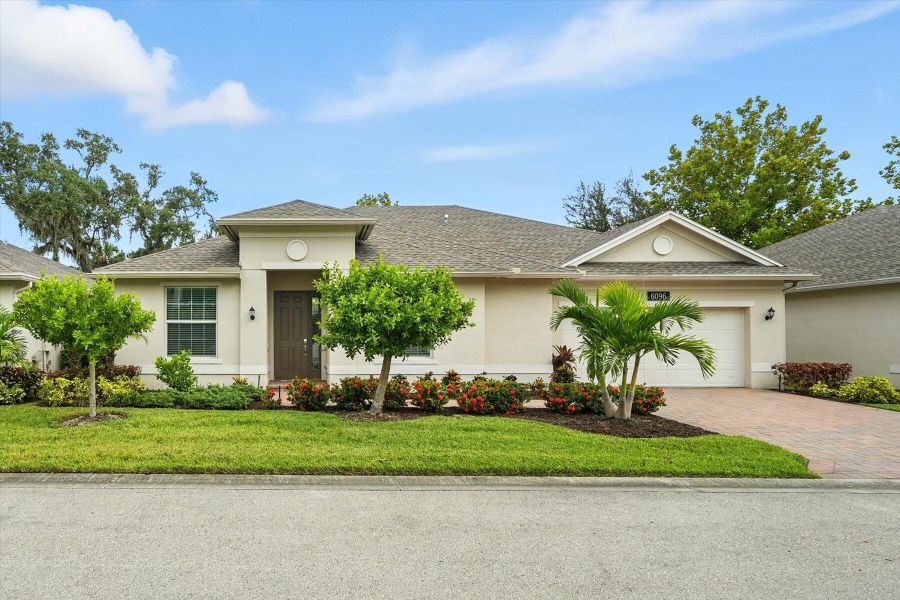 Front exterior of a new home in Bella Rosa, Vero Beach, FL, highlighting curb appeal (Image 24). Front exterior of a new home in Bella Rosa, Vero Beach, FL, highlighting curb appeal (Image 24).