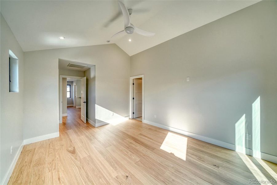 Primary Suite at end of hall looks to Additional Bedrooms